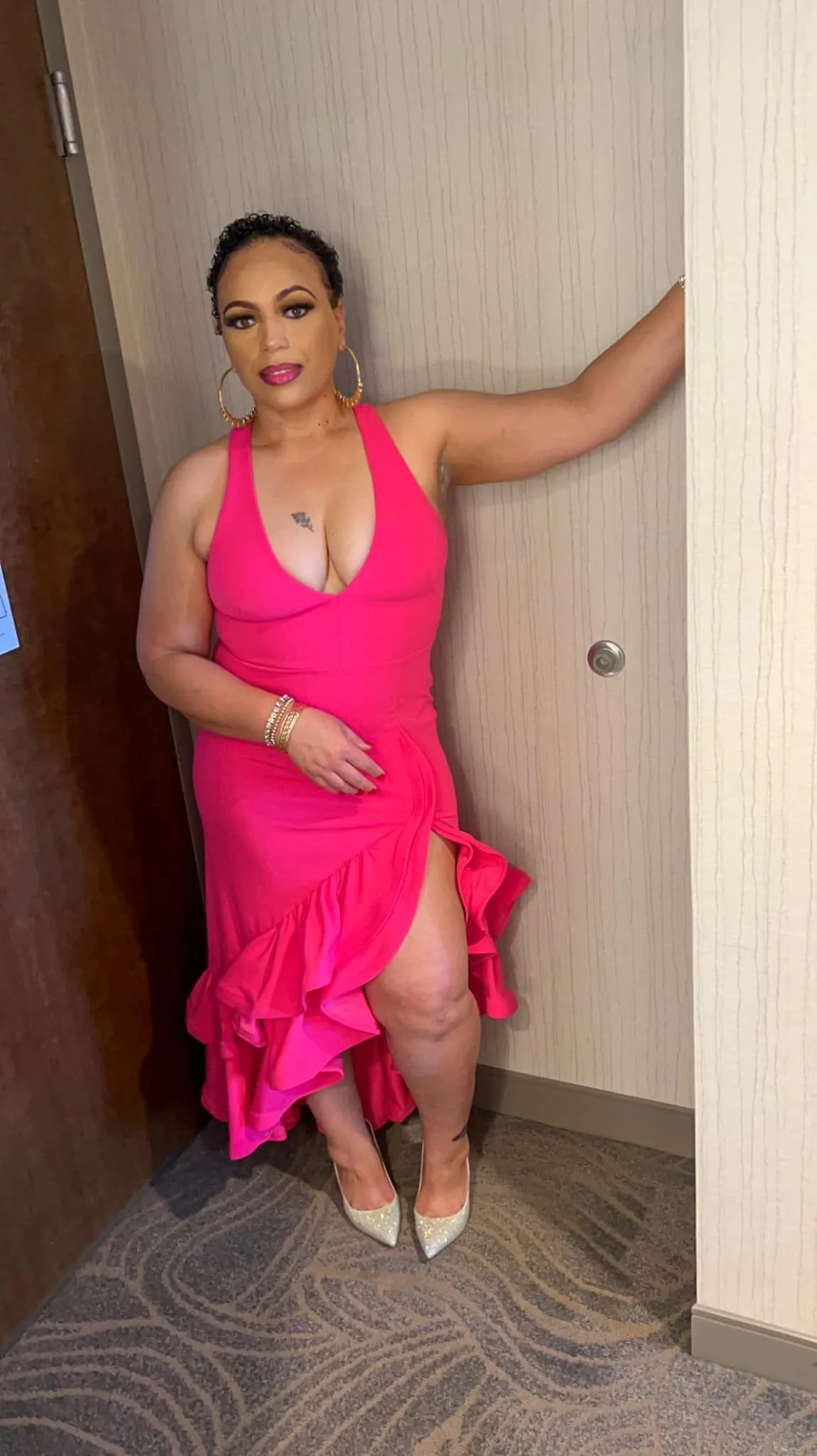 Hot-pink evening dress styled with gold hoop earrings