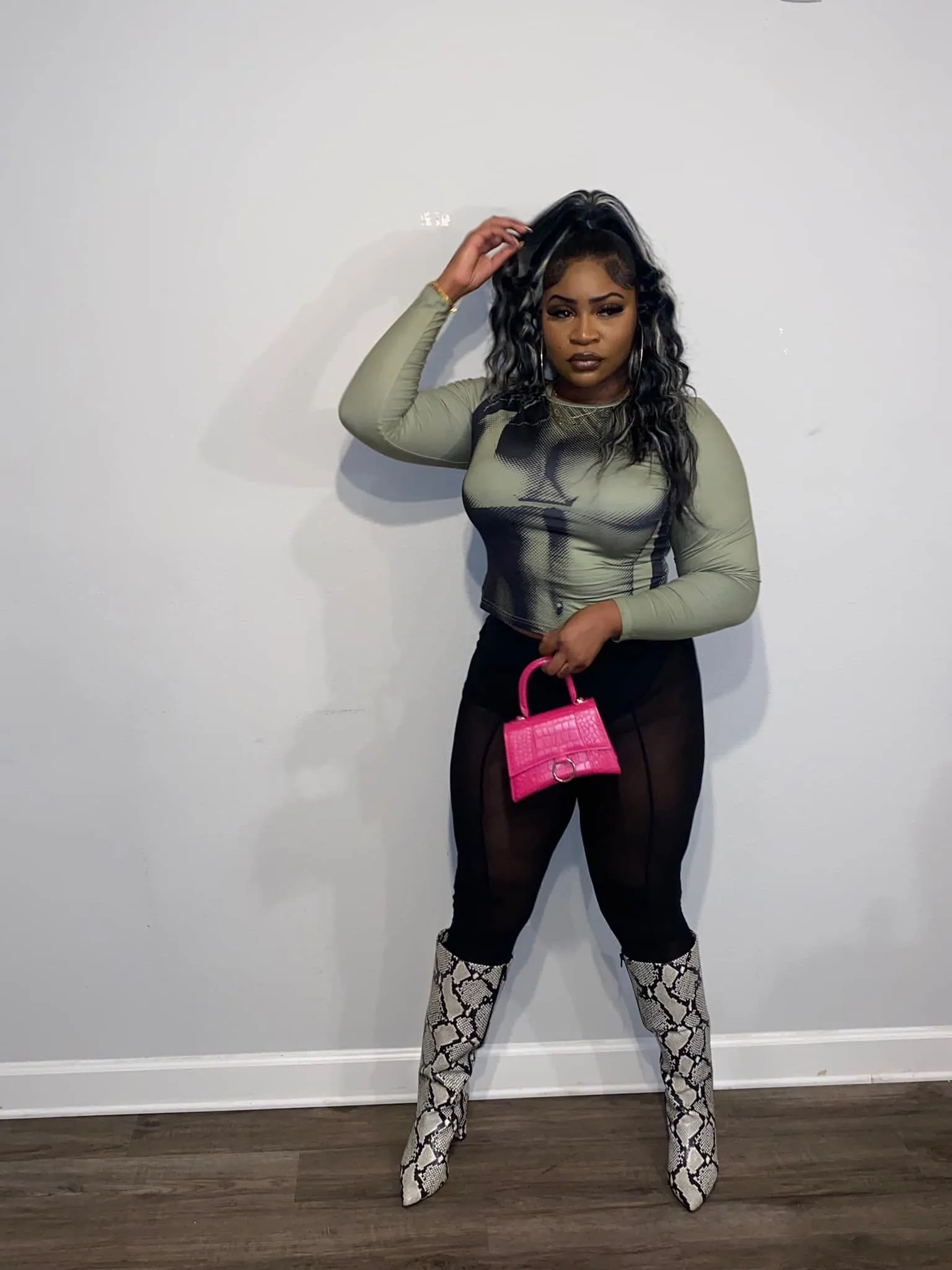 Sage printed top, sheer leggings, pink bag, and tall boots