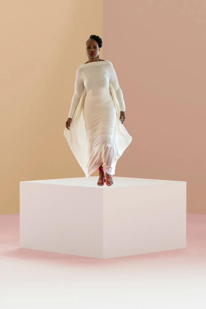 White gown with a flowing back and red sandals